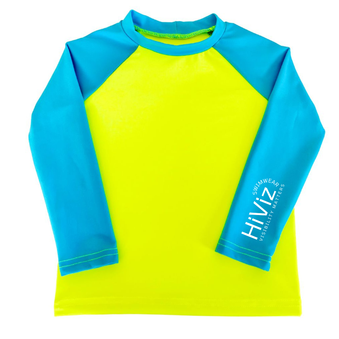 This is a product image of a bright rash guard, a neon yellow with blue sleeves rash guard with bright swimwear company HiViz's logo on the left sleeve.